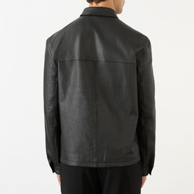 Model wearing Prada black nappa leather casual jacket, back view, with spread collar and clean-finish seams.