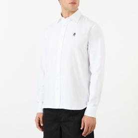 Model wearing Prada Crest Logo Oxford Shirt in white with embroidered crest logo, long sleeves and button fastening, styled with black trousers.