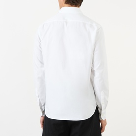 Model wearing Prada Crest Logo Oxford Shirt in white, rear view showing curved hemline and long sleeves with single cuffs.