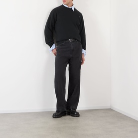 Model wearing Prada Logo Raglan Sweatshirt in black with light blue shirt, dark jeans and black loafers