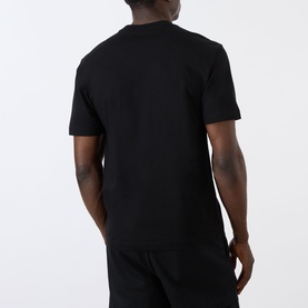 Model wearing Prada black cotton T-shirt, rear view, styled with matching black trousers