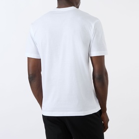 Model wearing Prada white cotton T-shirt, rear view, styled with black trousers.