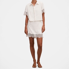 Model wearing Forever New porcelain short-sleeve shirt dress with lace hem detail, styled with brown flat sandals