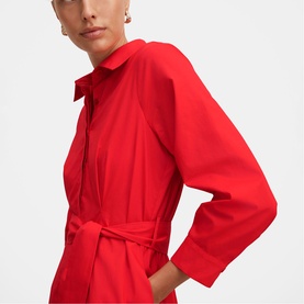 Model wearing Forever New red shirt dress with collar, long sleeves, zip front, and tie waist belt, cropped torso view