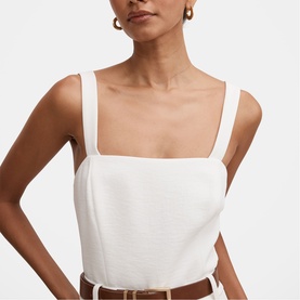 Model wearing Forever New porcelain square-neck cami top with wide straps, styled with a brown leather belt.