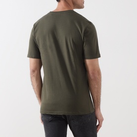 Model wearing Scotch & Soda T-shirt in Forest Night green, rear view, short sleeves, styled with dark jeans