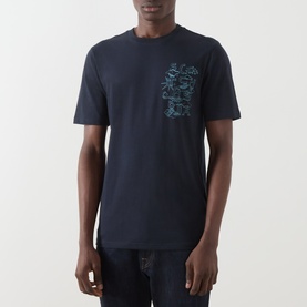 Model wearing Scotch & Soda Sky Captain navy cotton T-shirt with teal chest graphic print, styled with dark jeans.