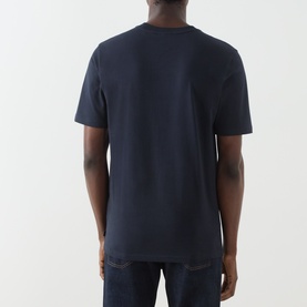 Model wearing Scotch & Soda Sky Captain navy cotton T-shirt, back view, styled with dark denim jeans