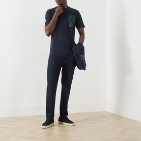 Model wearing Scotch & Soda Sky Captain navy cotton T-shirt with subtle chest print, styled with dark trousers and navy jacket
