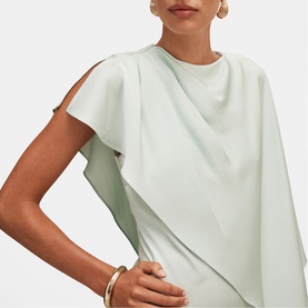 Model wearing Forever New Dusty Aqua dress with draped flutter sleeves, styled with a gold bangle bracelet