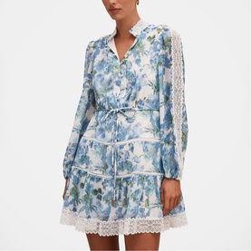 Model wearing Forever New Dangar Floral mini dress with long sleeves, V-neckline, tie waist, and lace trim hem detailing.