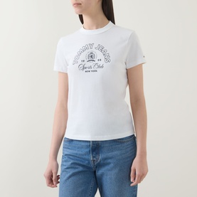 Model wearing Tommy Heritage Logo T-Shirt in ecru with crew neck and Heritage logo graphic, styled with blue jeans.