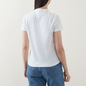 Model wearing Tommy Heritage Logo T-Shirt in Ecru, rear view, short sleeves, straight hem, styled with blue jeans.
