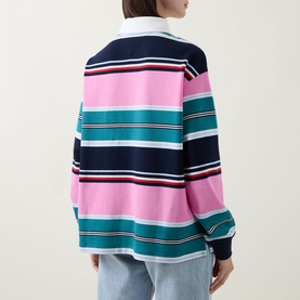 Model wearing Tommy Flag Logo Striped Rugby Top in Pink Daisy Multi Stripe, back view, showing contrast collar and long sleeves, styled with light