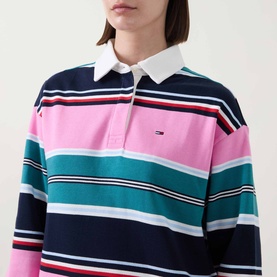 Model wearing Tommy Flag Logo Striped Rugby Top in Pink Daisy multi stripe with white contrast collar and embroidered flag logo.