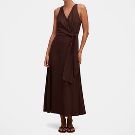 Model wearing dark brown sleeveless wrap midi dress with tie waist, styled with brown strappy flat sandals