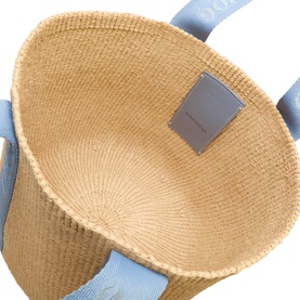 Chlo&eacute; Ashes Blue woven straw tote bag, interior view showing natural weave base and silver branded label with pale blue leather handles
