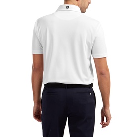 Model wearing white short-sleeve polo shirt, back view, styled with navy trousers