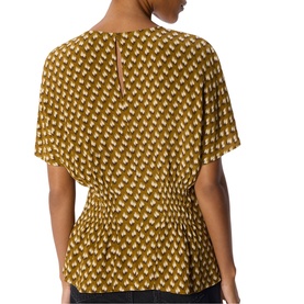 Model wearing Whistles green geometric print short-sleeve top with smocked peplum waist and keyhole back detail.