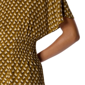 Model wearing Whistles green ikat-print dress, close-up of draped waist and flutter sleeve detail