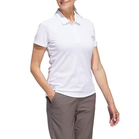 Model wearing Adidas Golf white short-sleeve polo shirt with zip collar detail, styled with grey trousers.