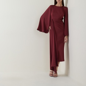 Model wearing Maisonel Draped Pencil Dress in Brick with cape-style sleeves, ruched waist detail and midi length, styled with strappy heels.