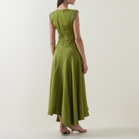 Model wearing Maisonel Beaded Drape Dress in Meadow, showing back view of gathered waist, asymmetric hemline, and beaded cap sleeves.