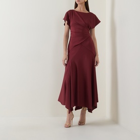 Model wearing Maisonel Gathered Scarf Dress in brick, midi length with asymmetric hem, gathered waist, short sleeves, styled with nude heels.