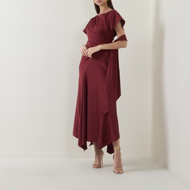 Model wearing Maisonel Gathered Scarf Dress in brick, midi length with asymmetric hemline and gathered waist detail, styled with nude heeled sandals.