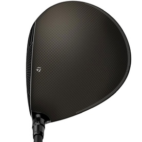 TaylorMade dark carbon driver head, top-down view showing textured crown and branded heel logo with black shaft