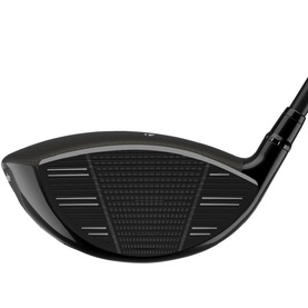 Black golf driver club head shown face-on, featuring textured strike face with geometric pattern and dark grey crown detail