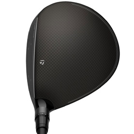 TaylorMade black driver golf club head, matte carbon crown finish with textured pattern, viewed from above at address angle