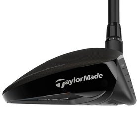 TaylorMade black golf fairway wood with carbon crown, black shaft, and orange accent detail on sole