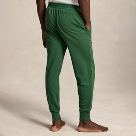 Model wearing Ralph Lauren Verano Green jogger bottoms, rear view, elasticated waistband and ribbed cuffs visible.
