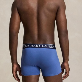 Model wearing Polo Ralph Lauren blue boxer trunks with branded navy and white elasticated waistband, rear view