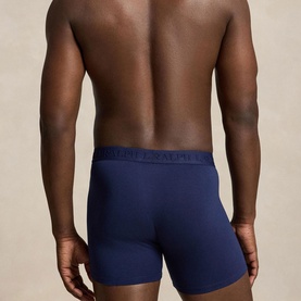 Model wearing navy blue fitted boxer briefs with tonal navy elasticated waistband, rear view