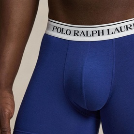 Model wearing Polo Ralph Lauren blue boxer briefs with white logo waistband, close-up detail shot