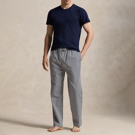 Model wearing Ralph Lauren Signature Pony Stripe Pyjama Bottoms in navy and white stripe with drawstring waist, styled with a navy T-shirt.