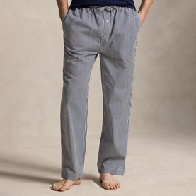Model wearing Ralph Lauren Signature Pony Stripe Pyjama Bottoms in Newport Navy stripe, elasticated drawstring waist, relaxed fit, bare feet
