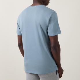Model wearing Ralph Lauren Script Logo Jersey Sleep Shirt in Cool Grey Blue, rear view, ribbed crew neck, short sleeves, paired with grey lounge