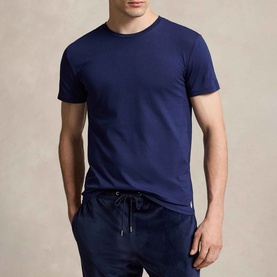 Model wearing Ralph Lauren Polo Player Navy Cotton T-Shirt, styled with navy drawstring trousers. Three-pack with ribbed crewneck and embroidered