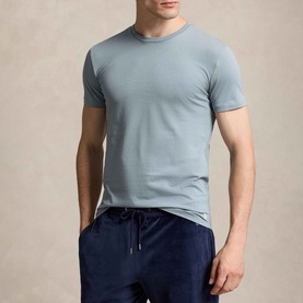 Model wearing Ralph Lauren Polo Player T-Shirt in navy cotton, styled with navy drawstring joggers. Ribbed crewneck, short sleeves