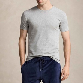 Model wearing Ralph Lauren Polo Player Navy T-Shirt Three-Pack, ribbed crewneck, short sleeves, styled with navy drawstring trousers