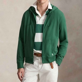 Model wearing Ralph Lauren Verano Green zip-up hoodie with white pony logo, styled with a striped polo shirt and white trousers.
