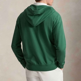 Model wearing Ralph Lauren Verano Green hoodie, back view, styled with white trousers