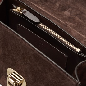 Valentino Rockstud Small Suede Shoulder Bag in Oak Brown, interior view showing zip pocket and gold-tone hardware clasp detail.