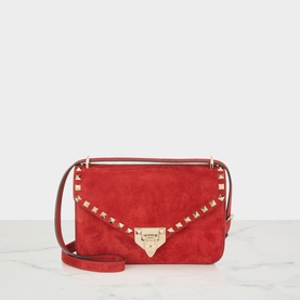 Valentino Garavani Rockstud red suede crossbody bag, gold-tone pyramid studs, flap closure with logo clasp, adjustable shoulder strap