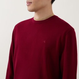Model wearing Calvin Klein Monogram Logo Knitted Sweater in Rhododendron, crew neck with tonal embroidered logo on chest