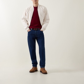 Model wearing Calvin Klein Monogram Logo Knitted Crew Neck Sweater in Rhododendron, styled with cream bomber jacket and dark indigo jeans.