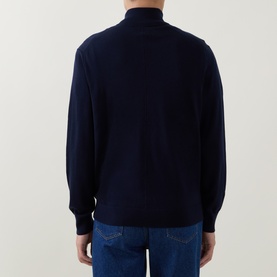 Model wearing Calvin Klein Monogram Logo Half-Zip Sweater in Dark Sapphire, back view, funnel neck, ribbed cuffs, styled with blue jeans